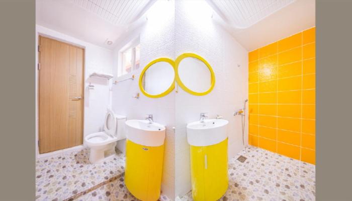 Postel nebo postele na pokoji v ubytování Red Windmill Pension