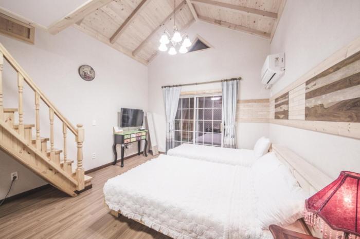 Postel nebo postele na pokoji v ubytování Red Windmill Pension