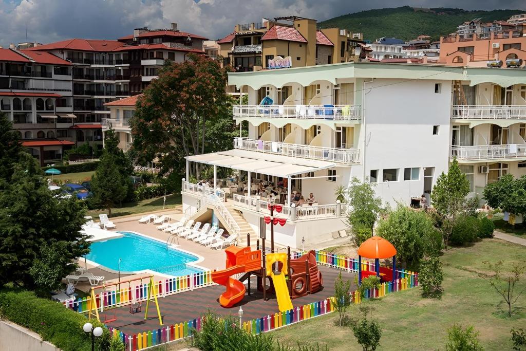 an apartment building with a pool and a playground at Hotel Panorama in Sveti Vlas