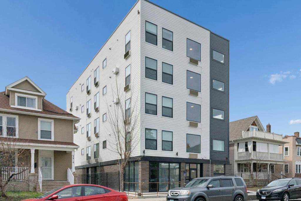 a tall building with cars parked in front of it at Valclyde Elevated Urban Haven in Minneapolis