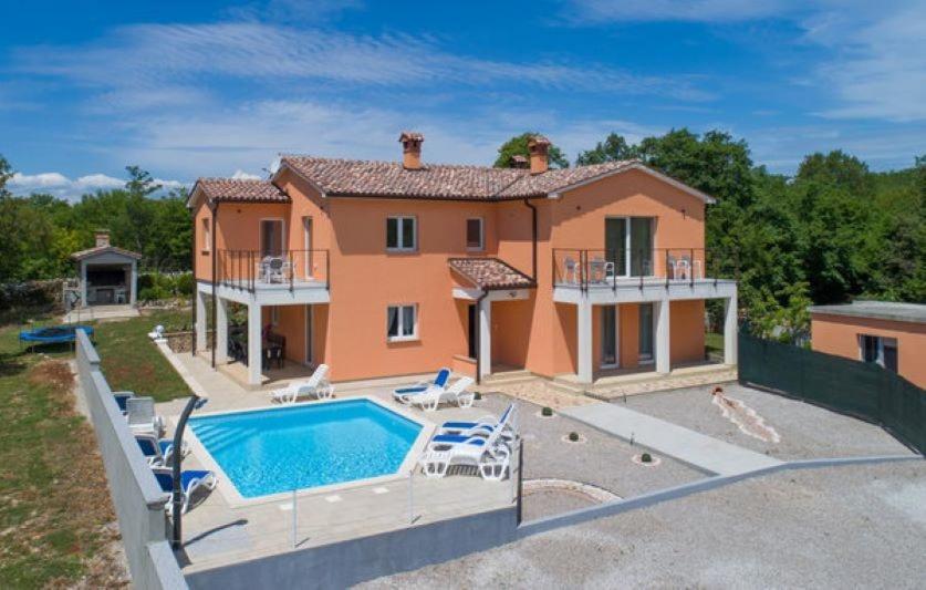 a house with a swimming pool in front of it at Villa Paola Vinez in Labin