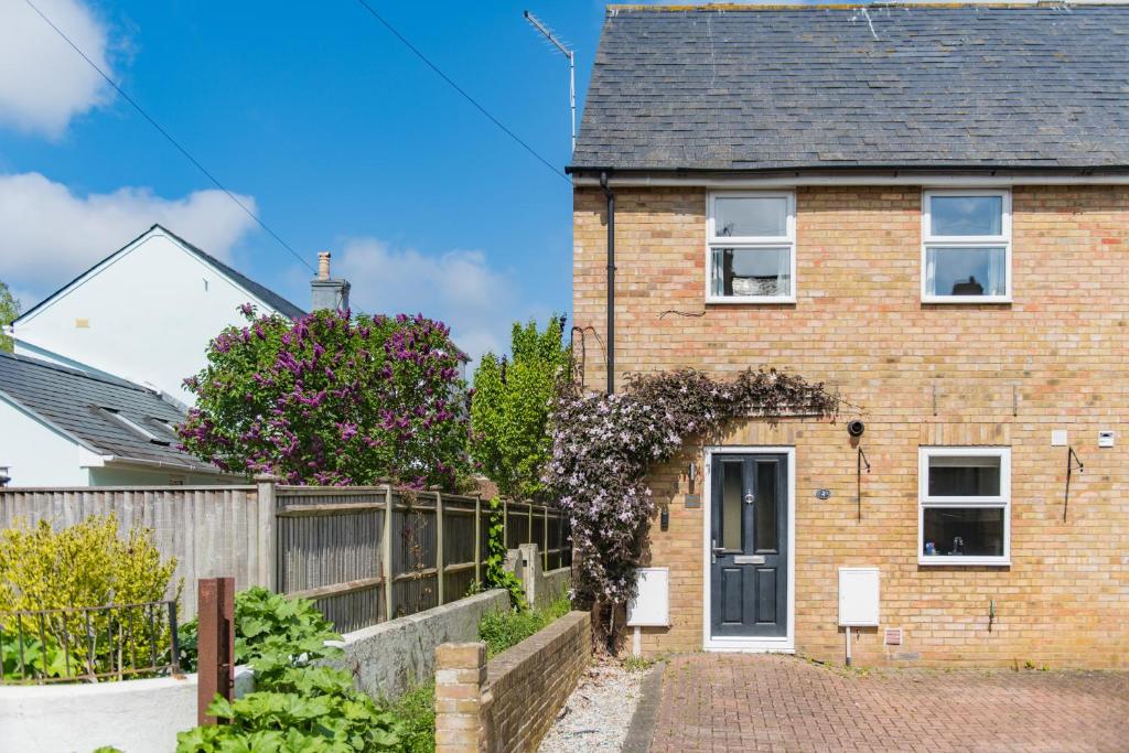 a brick house with a fence at Gerald's Place in Deal