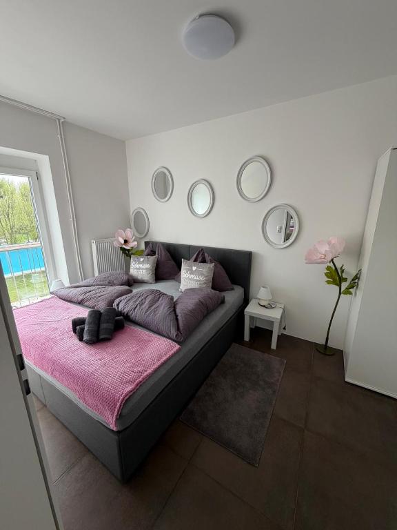 a bedroom with a large bed with a pink blanket at Ferienwohnung Sophia in Bad Gleichenberg