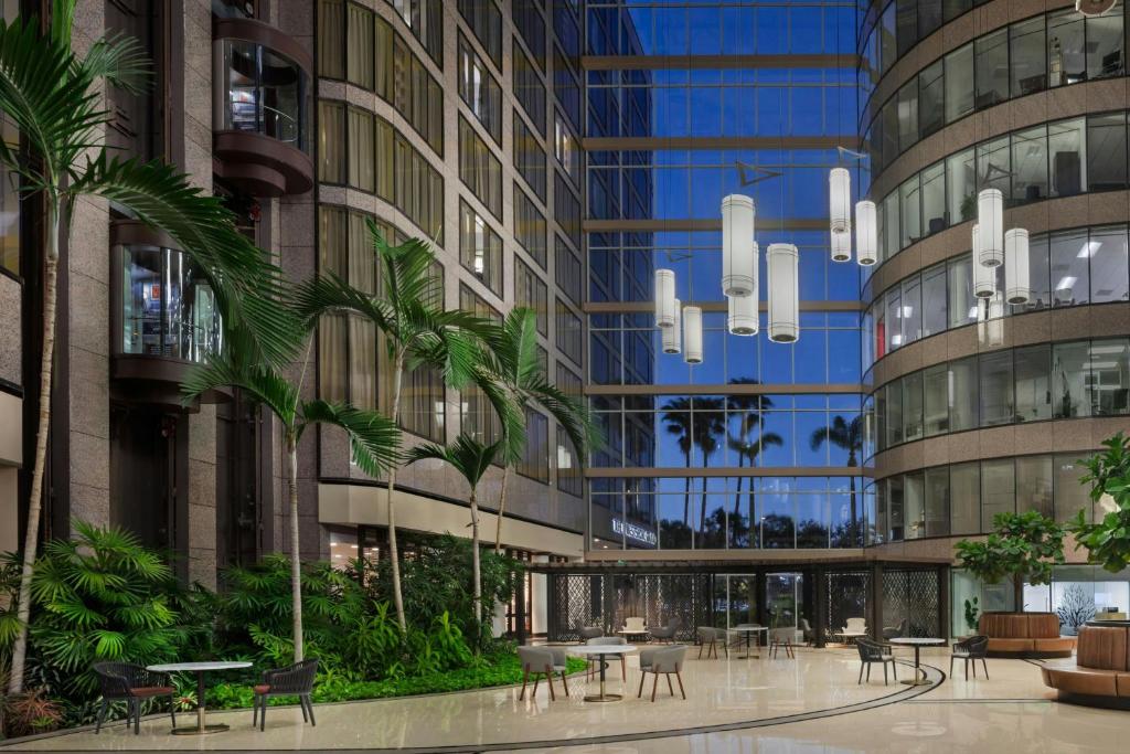 a rendering of a building with tables and chairs at The Westshore Grand, Tampa, A Tribute Portfolio Hotel in Tampa