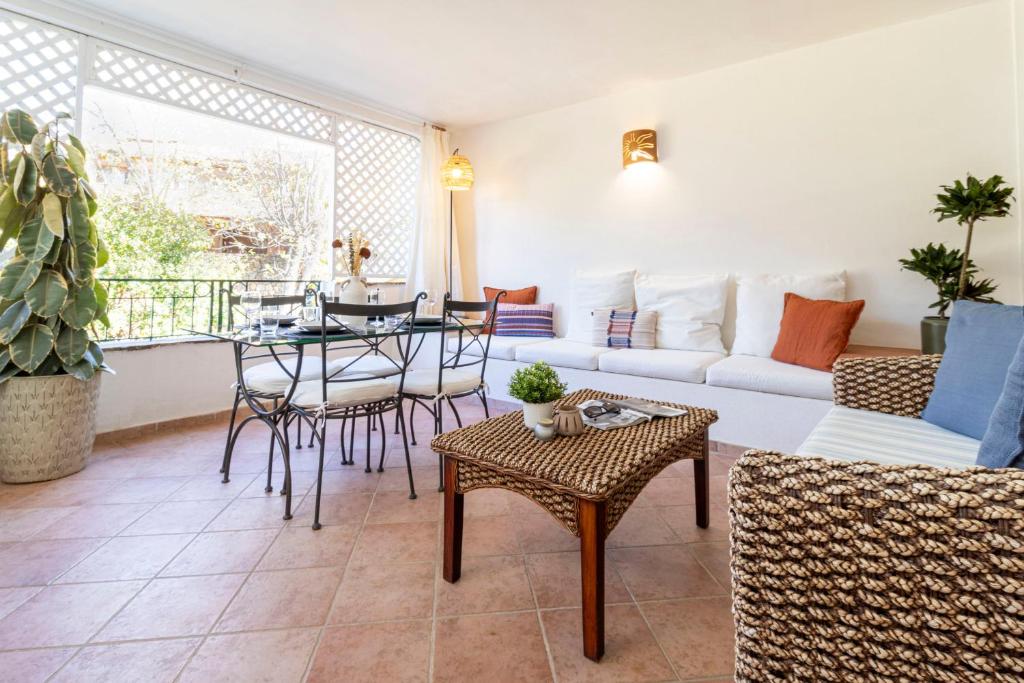 a living room with a couch and a table at Smeralda 15 in Porto Rotondo