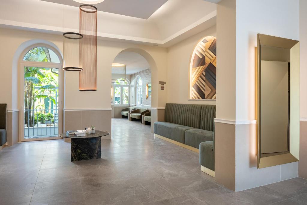 a lobby with a couch and a table at Hotel Astoria Garden in Rome