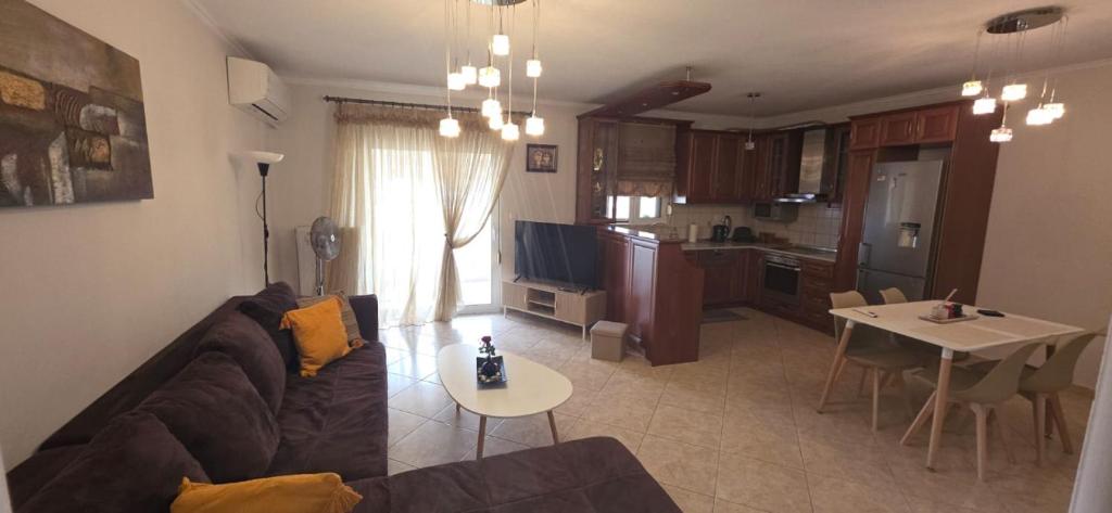 a living room with a couch and a table at ARM OV Apartment in Alexandroupoli