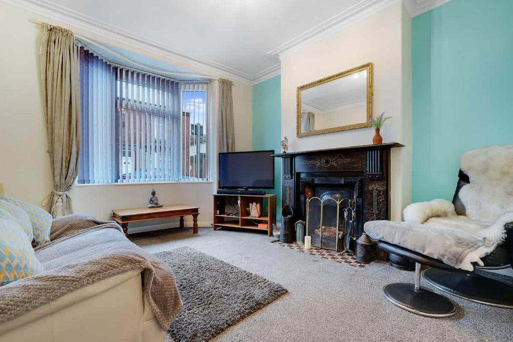 a living room with a couch and a fireplace at 2-Bedroom Stay with Free Wi-Fi Near Town Centre in Darlington