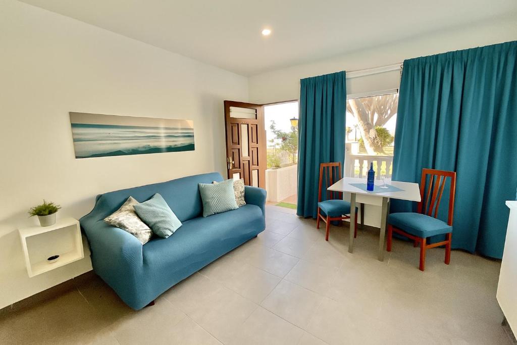 a living room with a blue couch and a table at Blue Oasis in Tacoronte