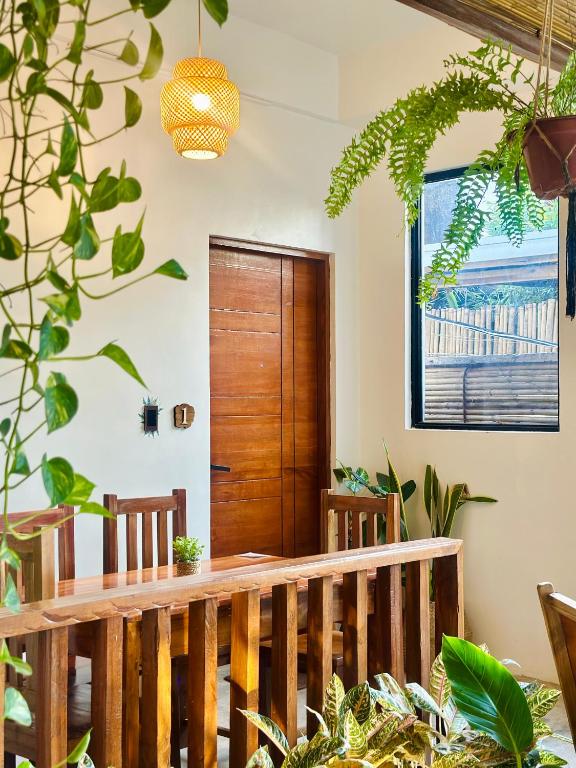 a wooden staircase in a room with plants at Calathea Suites El Nido in El Nido