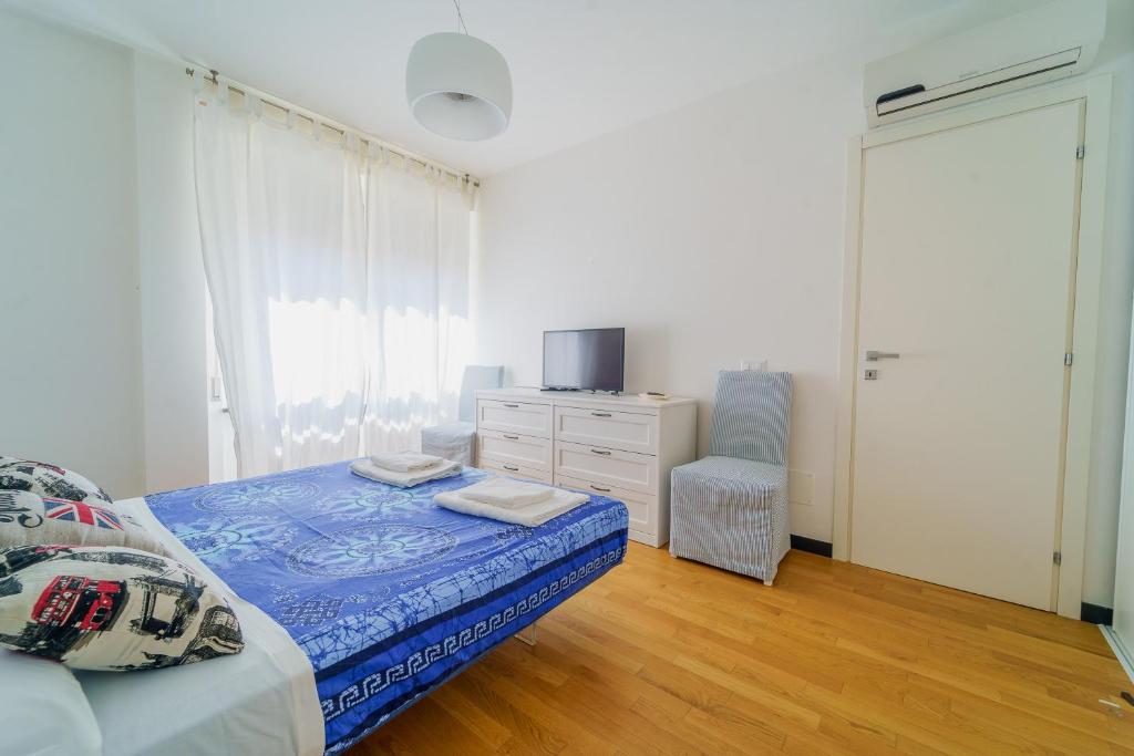 a bedroom with a bed and a dresser and a window at Nestly house Portovenere in Portovenere