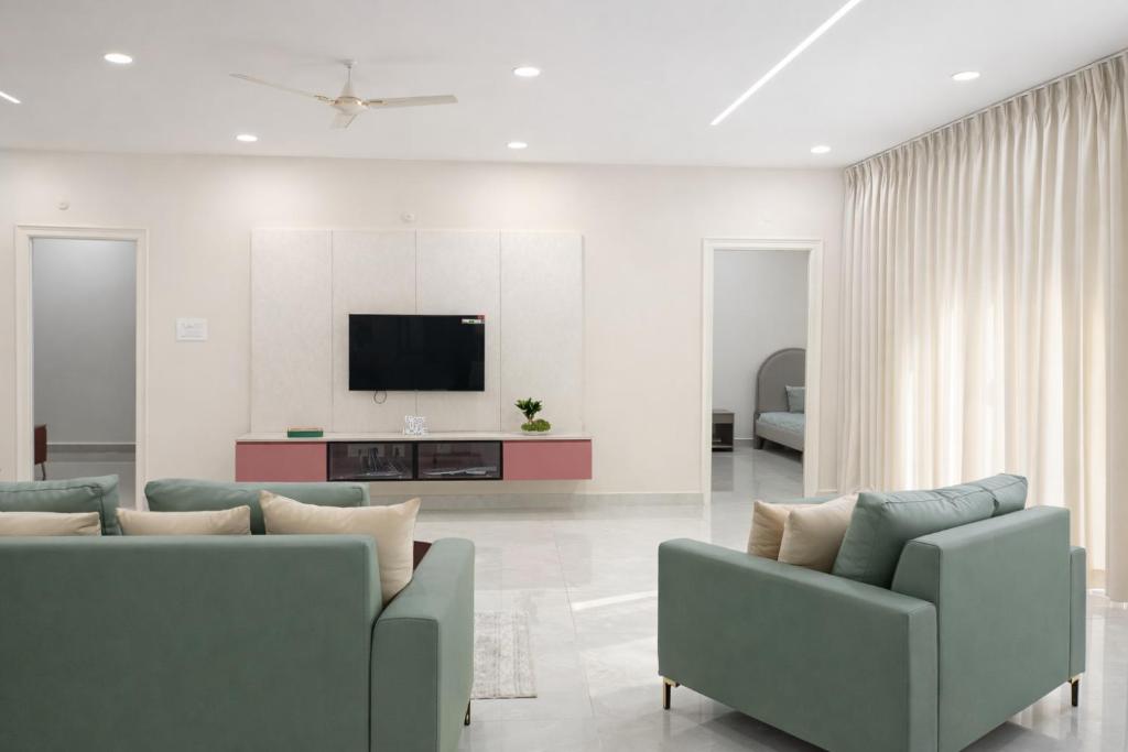 a living room with two couches and a tv at Chitrapuri - 3BHK Spacious Flat, Gachibowli Only for Families in Gachibowli