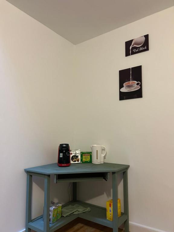 a blue table in a corner with a coffee maker on it at Chez Bobby in Montréal