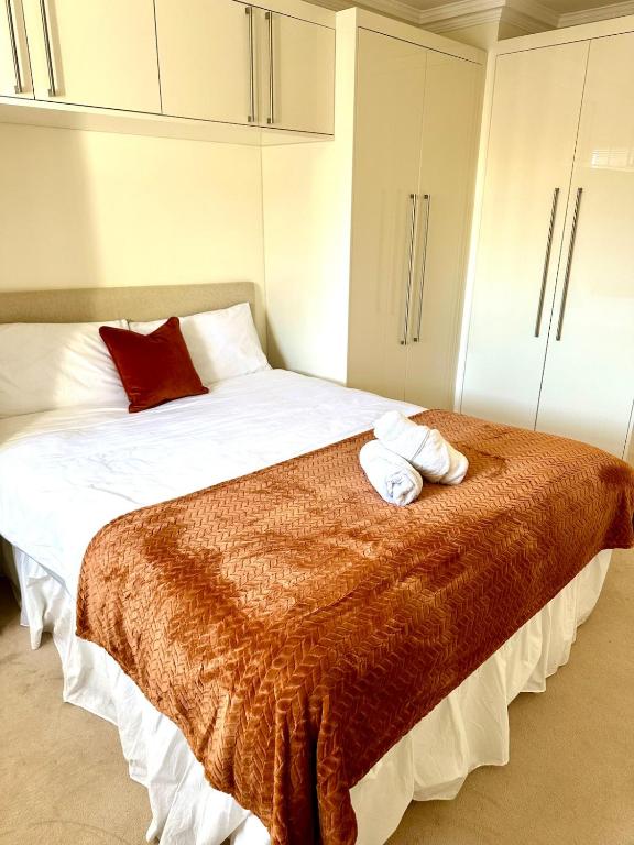 a bedroom with a large bed with two pillows on it at Russell Square Beautiful Quality Apartment in London
