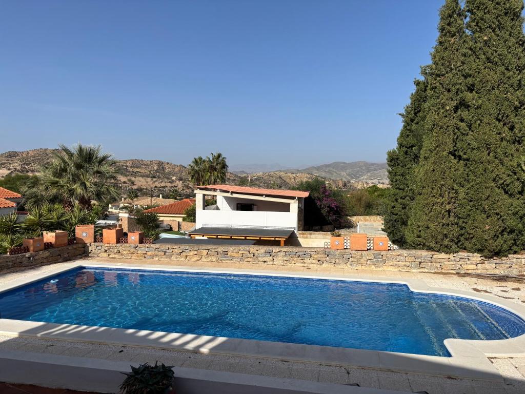 a swimming pool in front of a house at Villa Canario in Arboleas