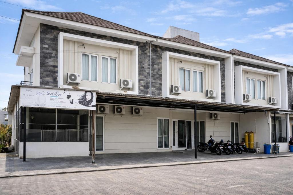 a building with motorcycles parked in front of it at Sanga Hotel in Gabung