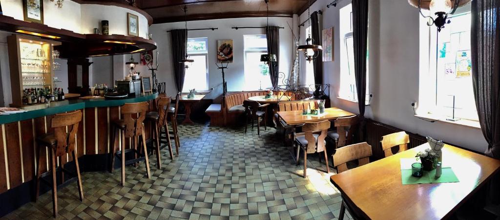 a bar with wooden tables and chairs in a restaurant at Ratskeller in Salzhemmendorf