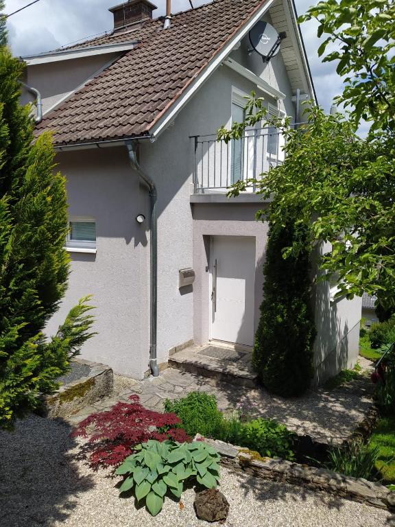a white house with a white door and some plants at Villa Siegrid in Kremsmünster