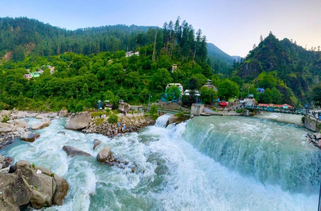 a waterfall at a water park in the mountains at The Royal Peaks in Kundālshai