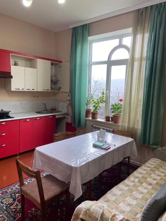 a kitchen with a table and a kitchen with a window at Holiday home in Qusar