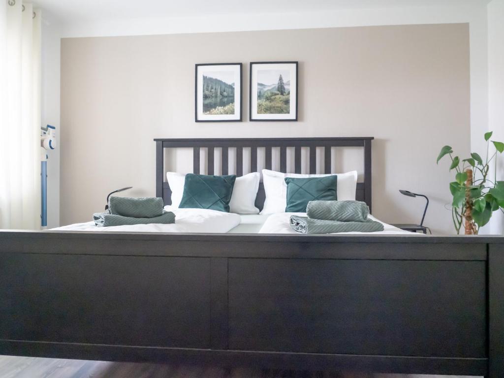 a bedroom with a large bed with two pillows on it at Ferienwohnung Schwarzwald Lodge in Schömberg