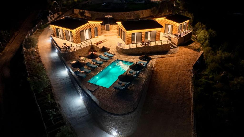 an aerial view of a house with a swimming pool at Dreamy Farm in Sarandë