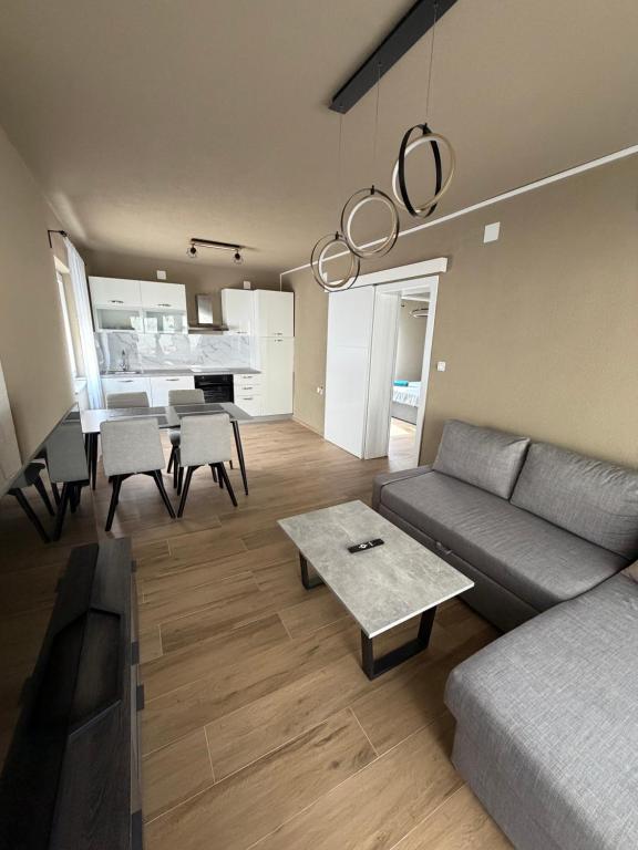 a living room with a couch and a table at SeaLaVir Apartments in Vir