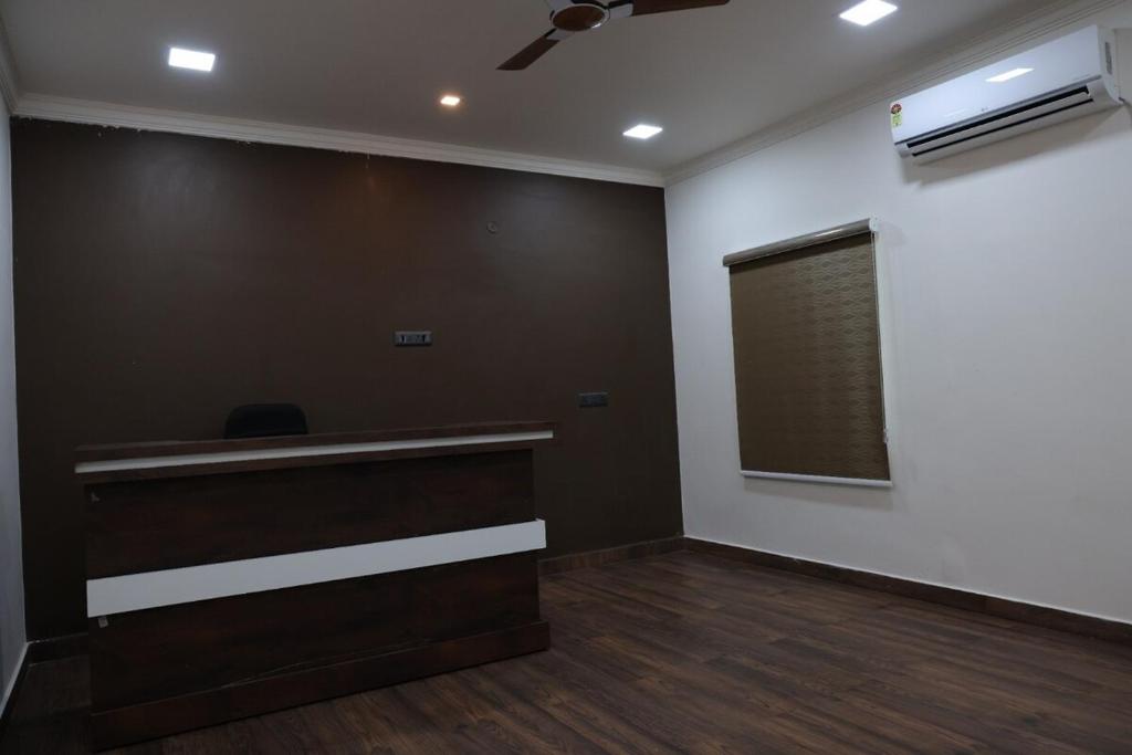 an empty room with a desk and a window at Premium House or Office In Amaravati in Sūriapālem