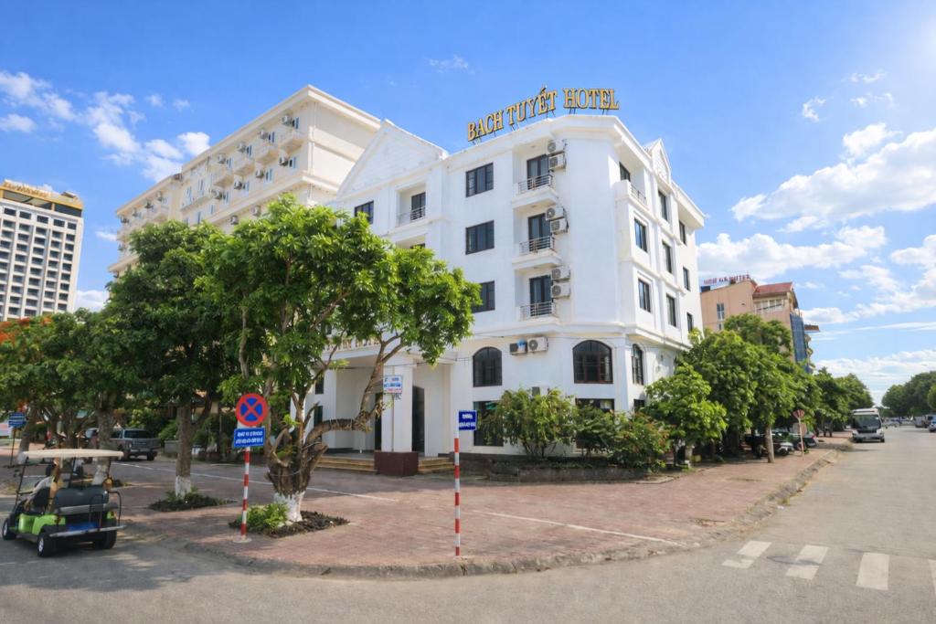a white building with a sign on top of it at Bạch Tuyết Hotel in Cửa Lô