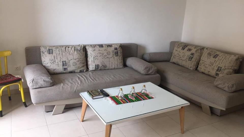 a living room with a couch and a coffee table at Studio with private beach Folla Residence in Akouda