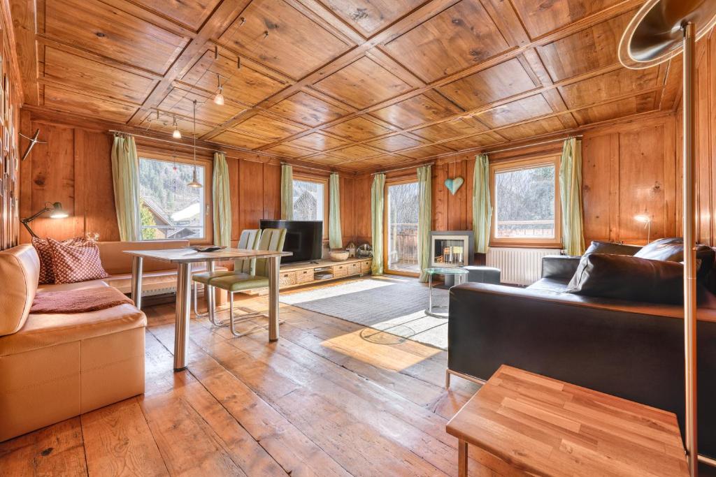 a living room with a couch and a table at Appartement Walserstuba by A-Appartments in Brand