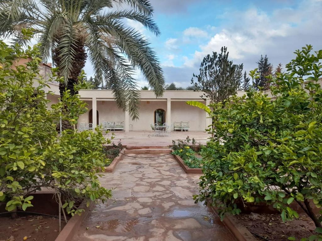 an exterior view of a house with a garden at Riad NACIRIA in Aït Ourir