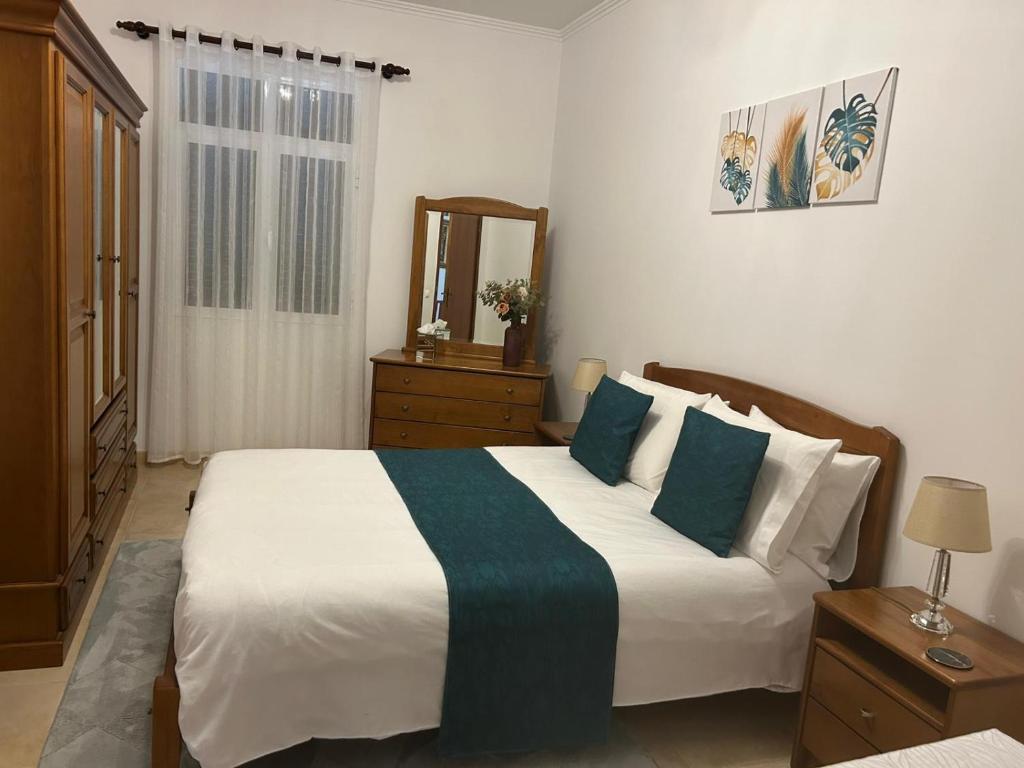 a bedroom with a large bed and a mirror at Casa do Pico in Ribeira Brava