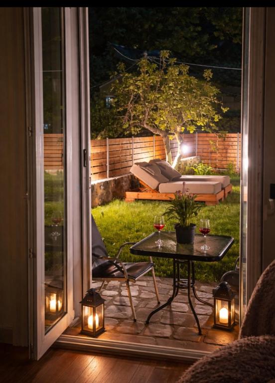 a patio at night with a table and lights at Kallistis Home in Kontokali