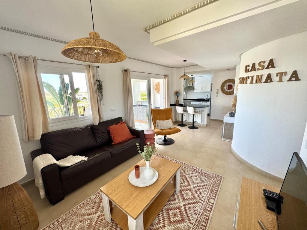 a living room with a couch and a table at Casa Sofinata with Pool View & Golf in Sucina