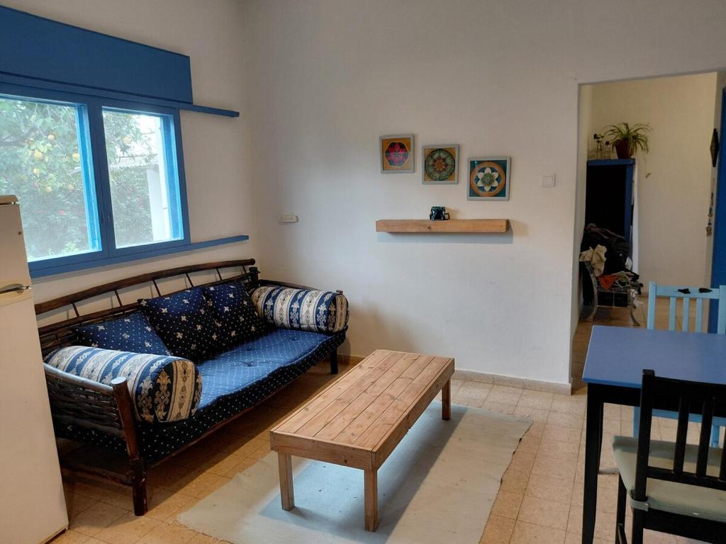 a living room with a couch and a table at Amit house in Pardes H̱anna
