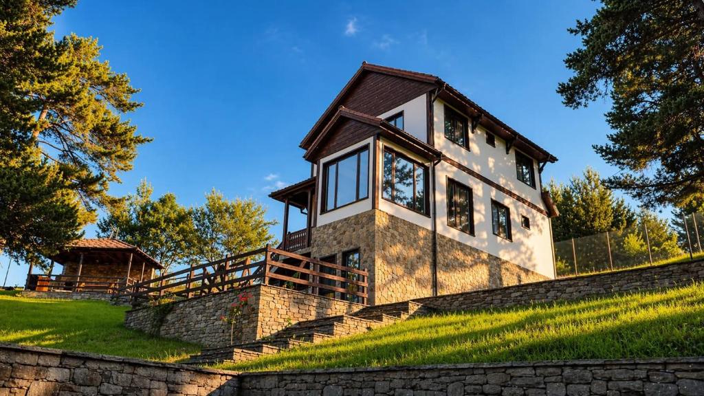 a house on top of a stone wall at Лунен залив in Dospat