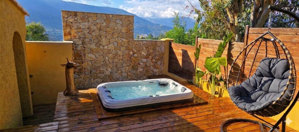 a hot tub sitting on a deck with two chairs at Maison Casa Milesa - Calme, Spa privatif sur demande, Parking securisé, à 12 min des plages in Nice