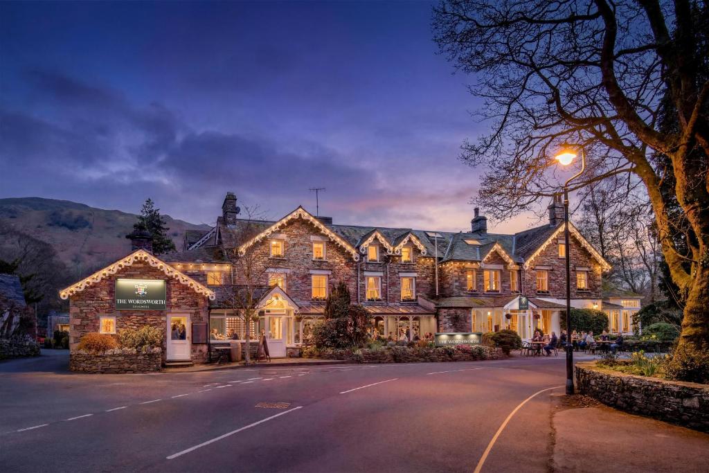 a large house on a street at night at The Wordsworth, Grasmere - The Inn Collection Group in Grasmere