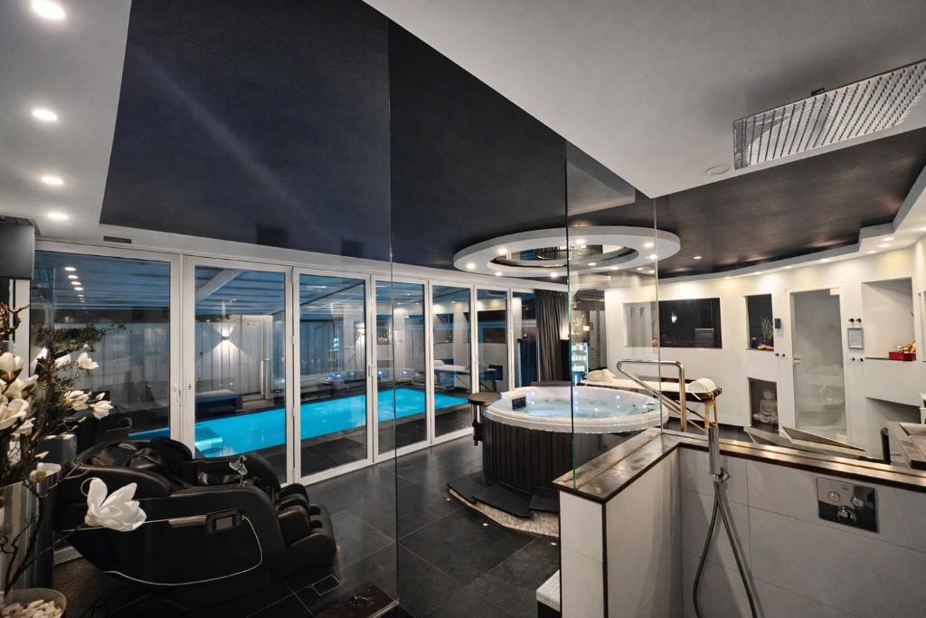 a room with a swimming pool and a living room at Bed & Wellness Angie in Almere