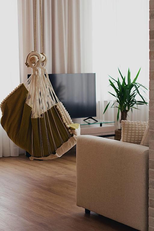 a living room with a couch and a table at Not A Hotel Cesis in Cēsis