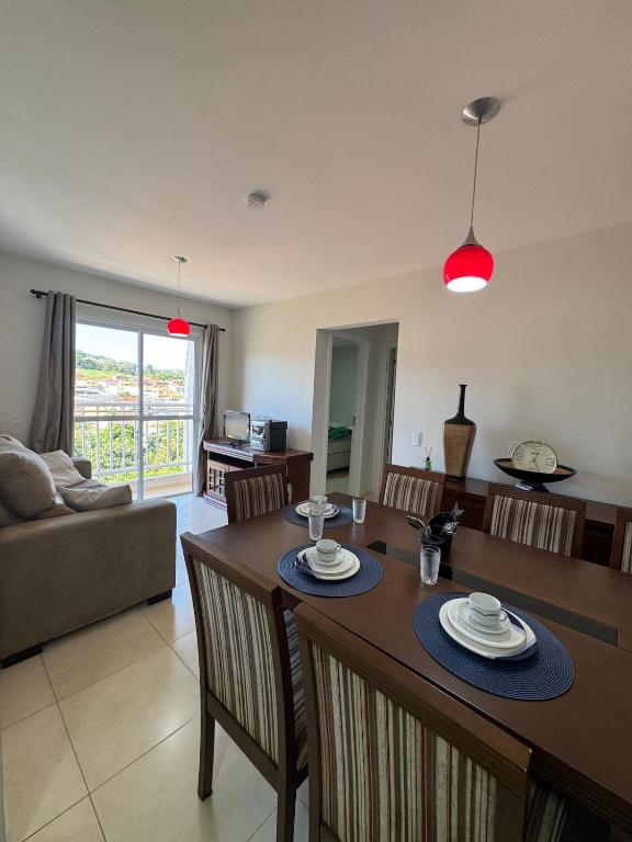 a kitchen and living room with a table and chairs at Apartamento Melbela IV AP 41 in Espirito Santo Do Pinhal