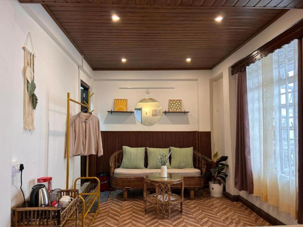 a living room with a couch and a table at The Boho Darjeeling in Darjeeling