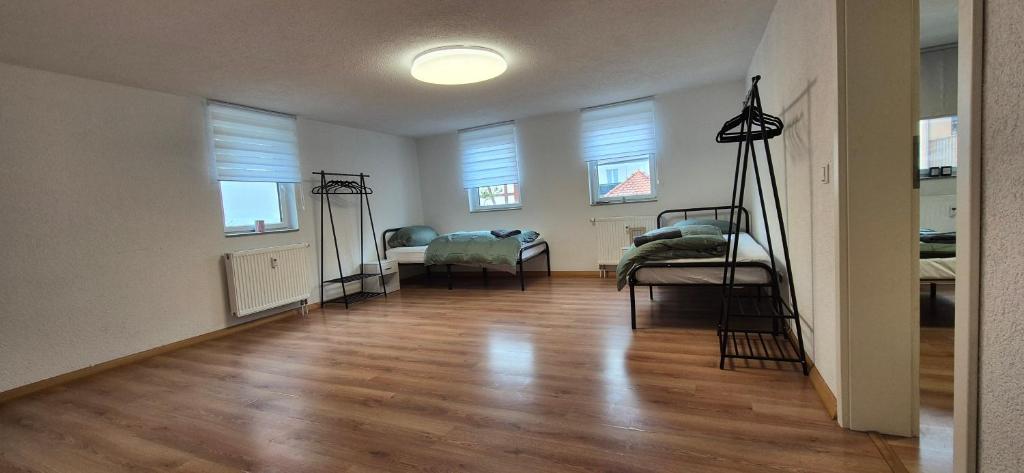 a living room with a hard wood floor and windows at Apartment in Vaihingen an der Enz - Ensingen in Vaihingen an der Enz