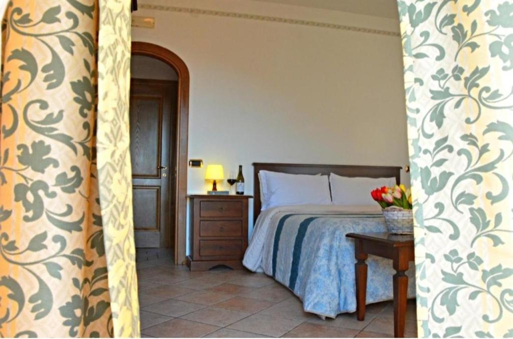 a bedroom with a bed and a table with a lamp at La Locanda in Agerola