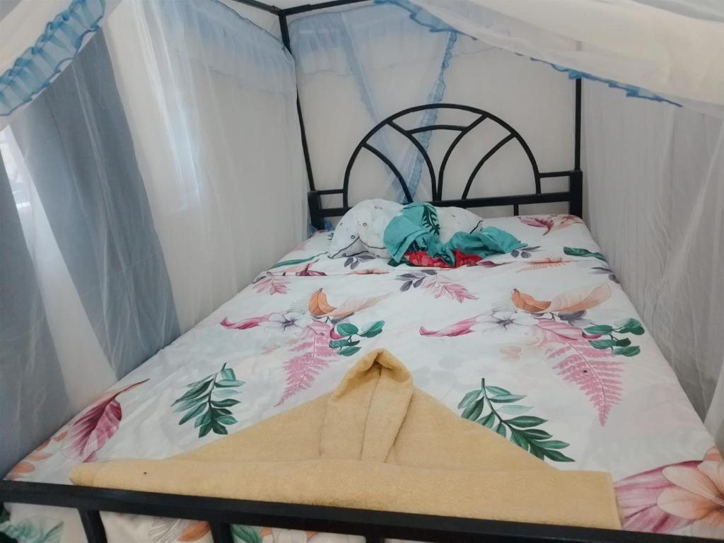a bedroom with a bed with a canopy at Ibus Nawi Homes 2 in Lodwar