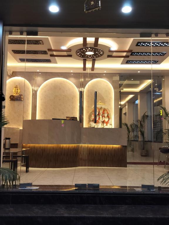 a lobby of a restaurant with a table and chairs at Hotel Panchvati in Durgāpur
