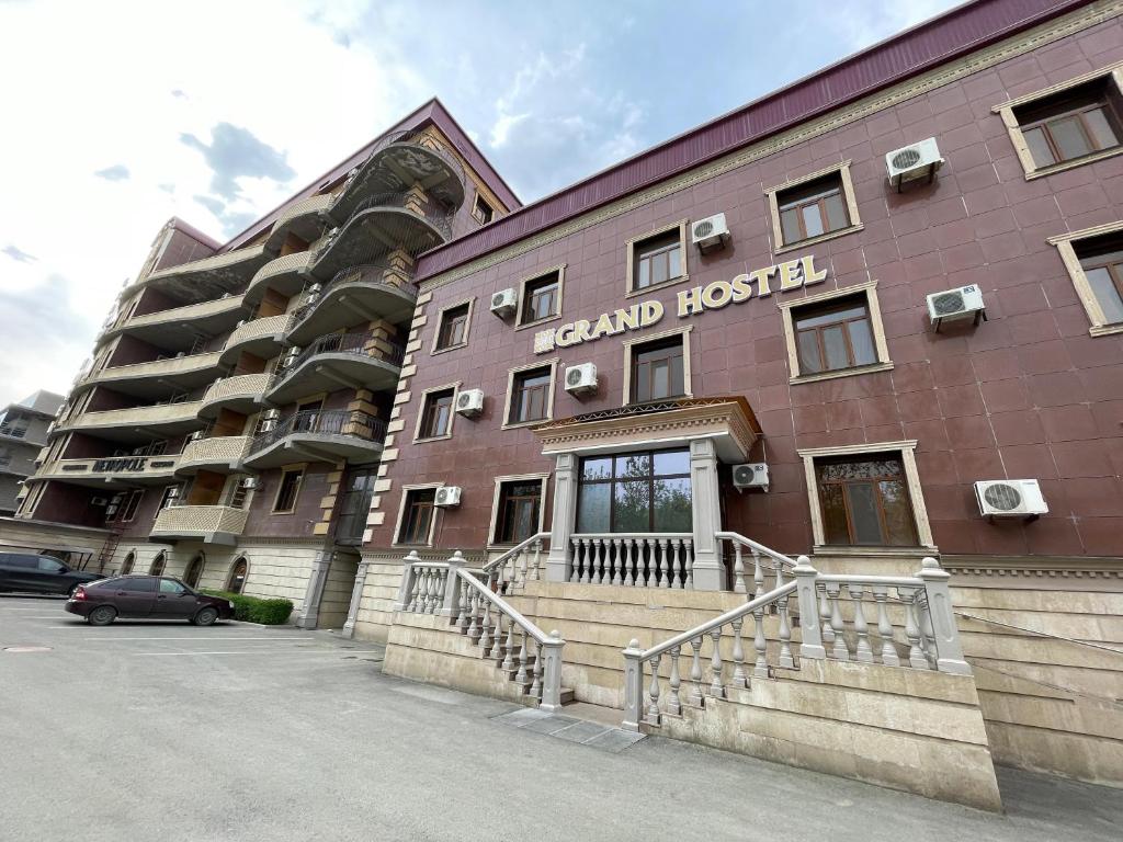 a large red building with a hotel at ATB Grand Hostel in Atyrau