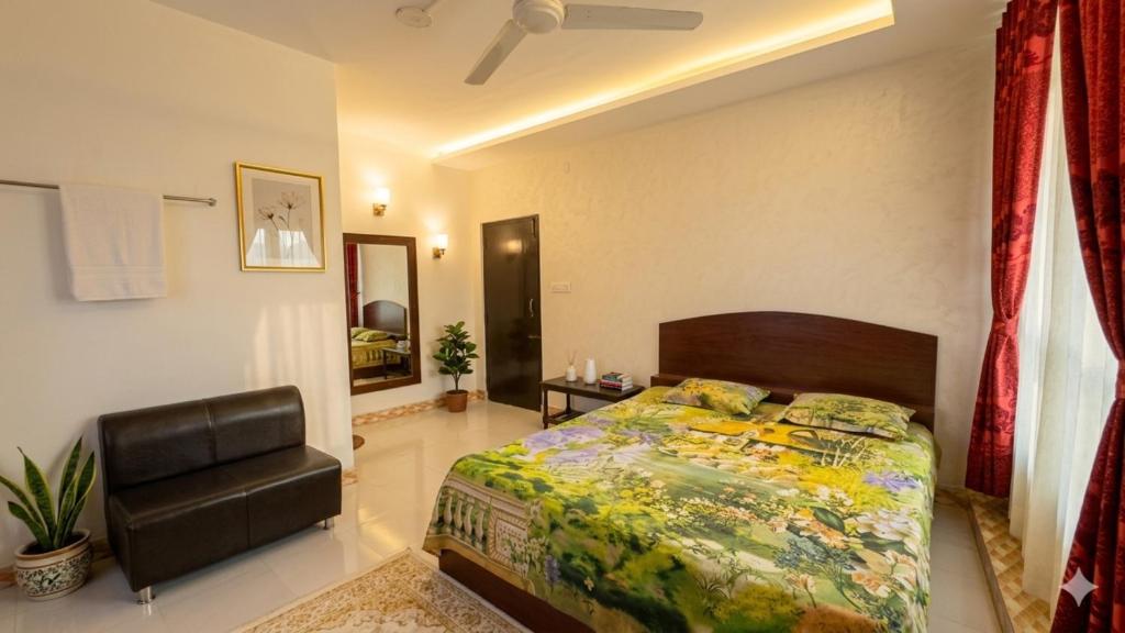 a bedroom with a bed and a chair in it at Hotel Priyatama Residential in Dhaka