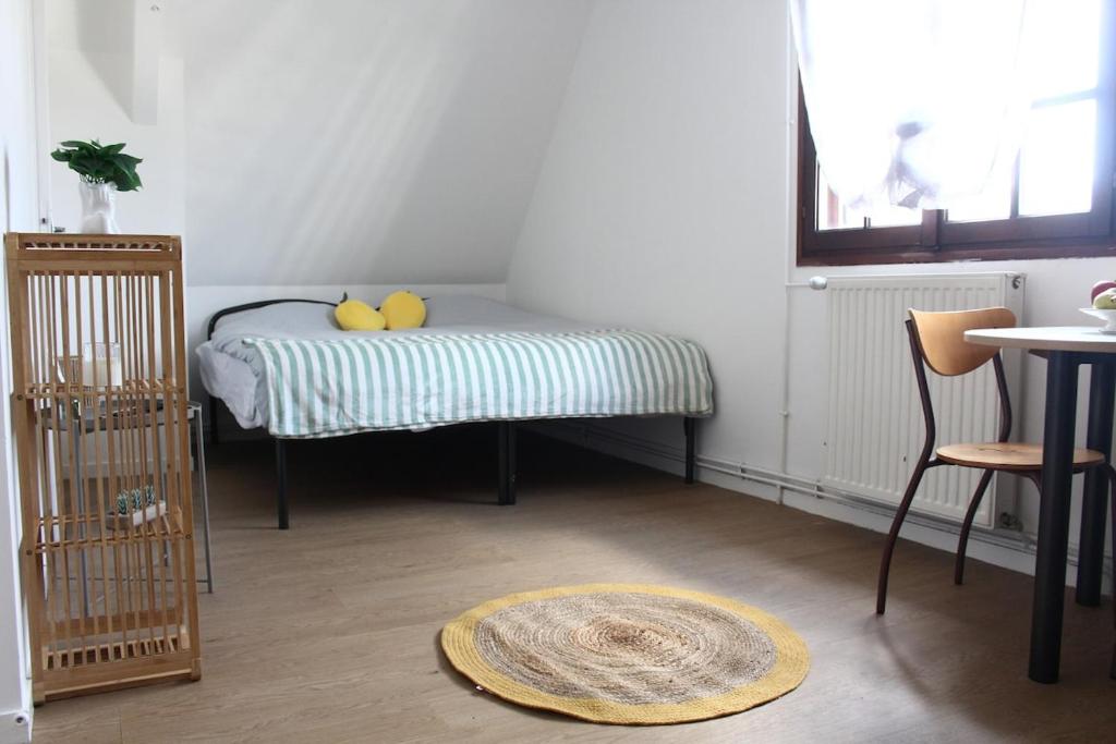 a room with a bed with two rubber ducks on it at L Atelier du Centre in Vendôme